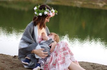 Mother Pleasantly Feeding The Baby