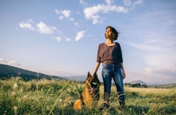 Girl-Standing-In-A-Field-With-Her-German-Shepherd-Dog